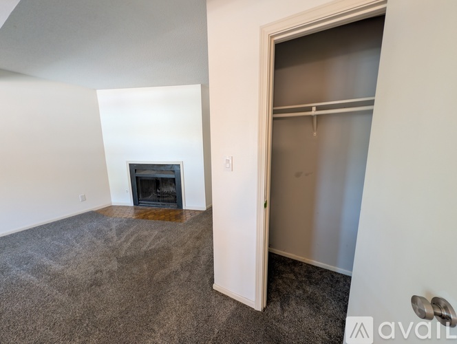 A kitchen with wooden cabinets and a grey fridge.