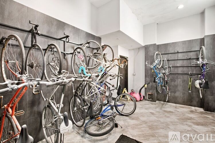 A room full of bicycles hanging on the wall.