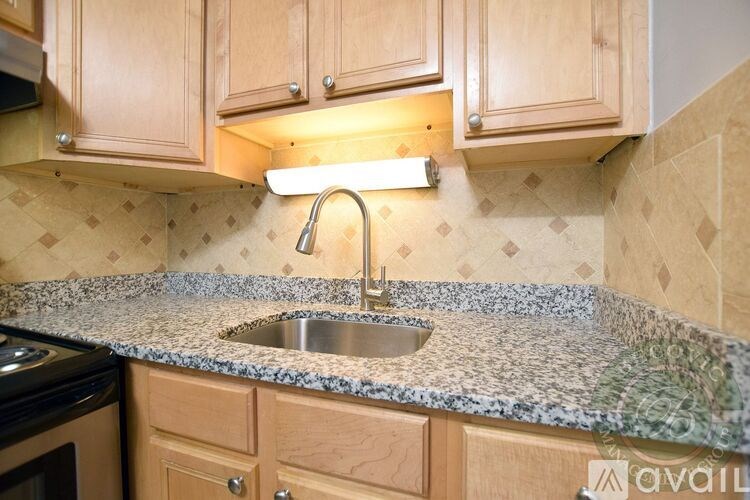 A kitchen with wooden cabinets and a granite countertop.