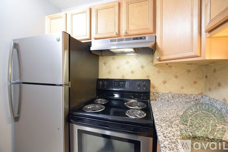 A kitchen with a stove and refrigerator.