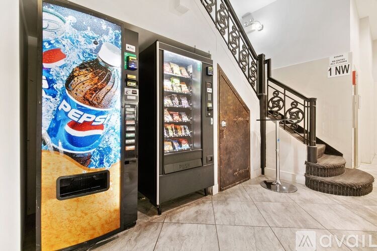 A Pepsi vending machine sits next to a staircase.
