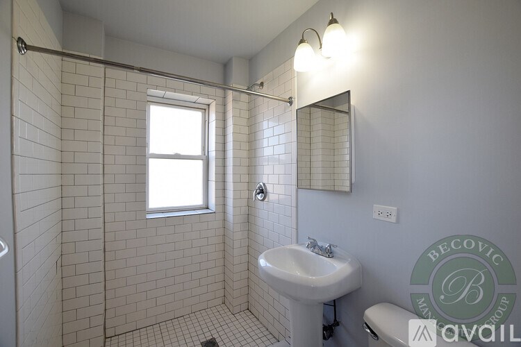 A bathroom with a white sink and a window.