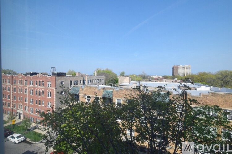 A view of a cityscape with buildings and trees.