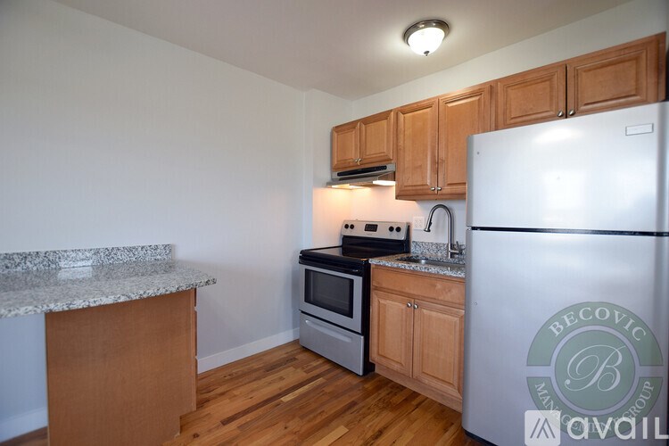 A kitchen with wooden cabinets and a white refrigerator.