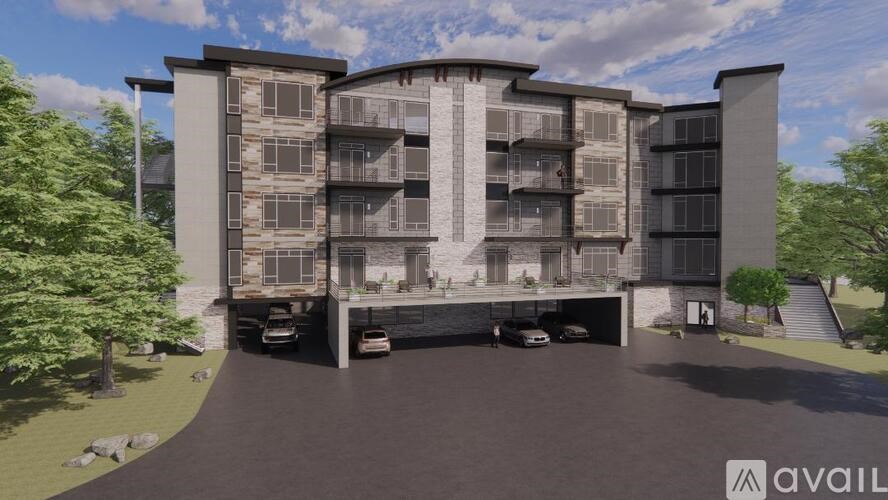 A modern apartment complex with a parking garage in front.