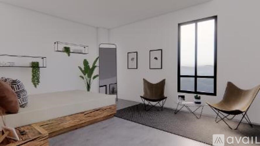 A living room with a couch, two chairs, and a plant.