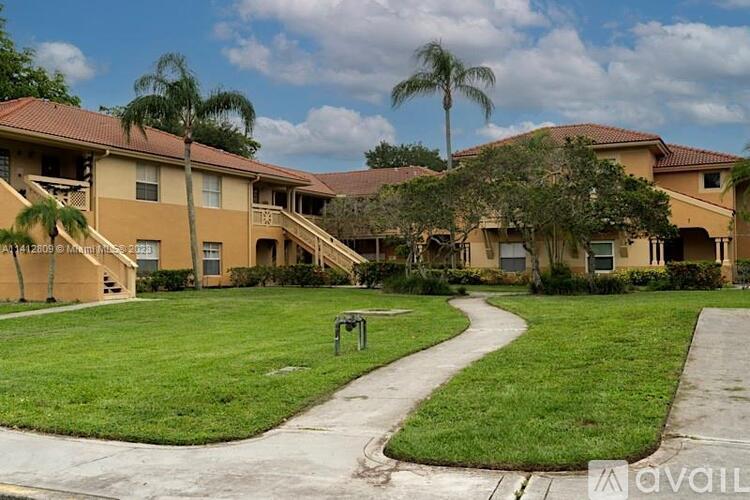 A grassy area in front of apartment buildings.