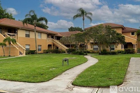A grassy area in front of apartment buildings.