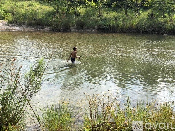 A person is wading in a river.