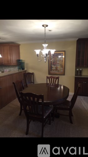 A dining room with a table and chairs.