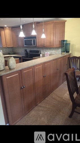 A kitchen with wooden cabinets and a granite countertop.
