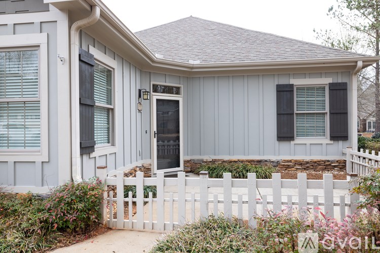 A house with a grey exterior and a black door.