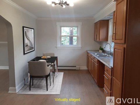 A kitchen with a table and chairs in the middle of the room.