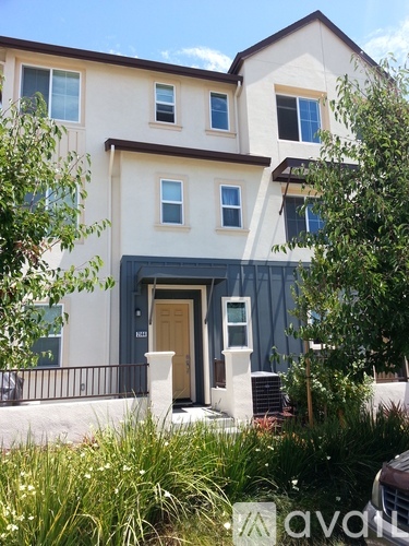 A two-story house with a brown door and windows.