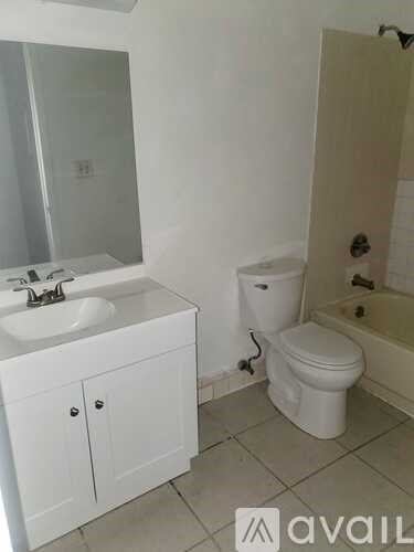 A white bathroom with a sink, toilet and bathtub.