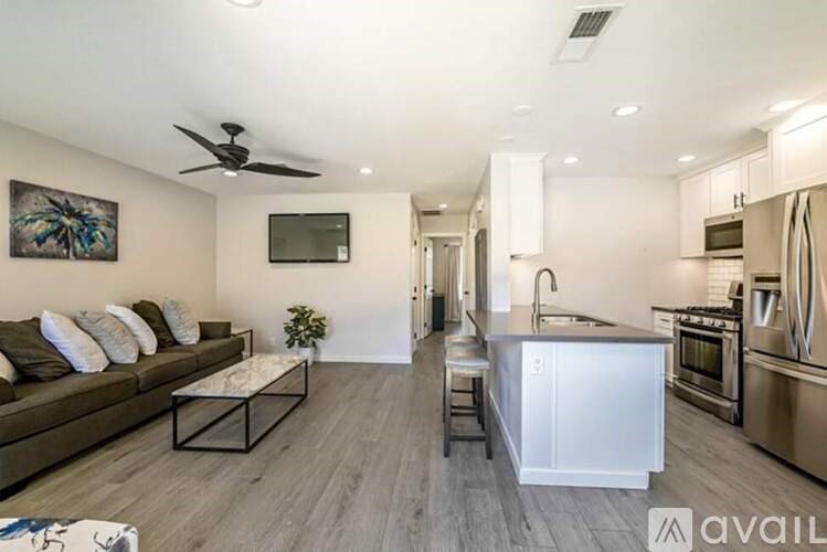 A modern kitchen with stainless steel appliances and a white island.