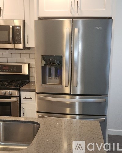 A kitchen with a stainless steel refrigerator and oven.