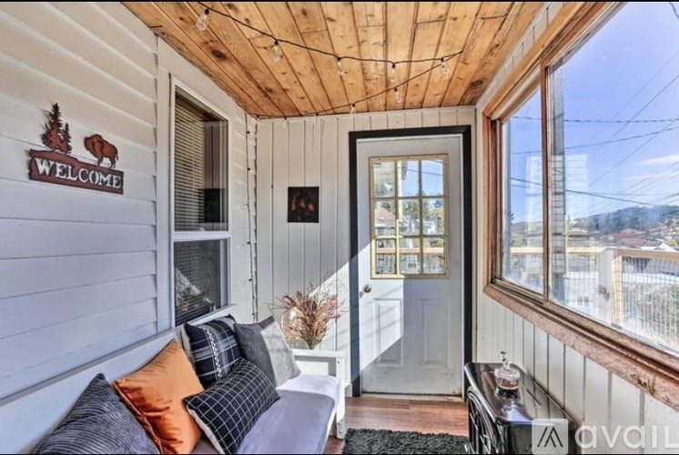 A cozy room with a wooden ceiling and a sign that says "Welcome" on the wall.