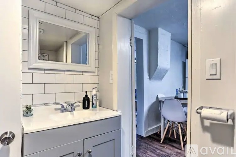 A bathroom with a white sink and a mirror above it.