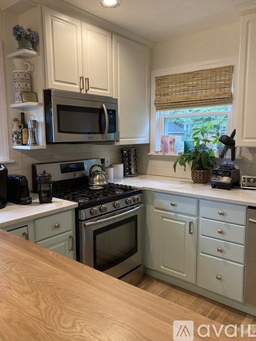 A kitchen with a wooden table in front of it.