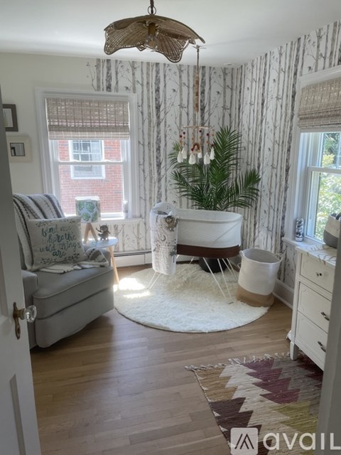 A living room with a white couch and a wooden floor.