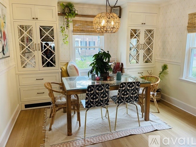 A dining room with a glass table and chairs.