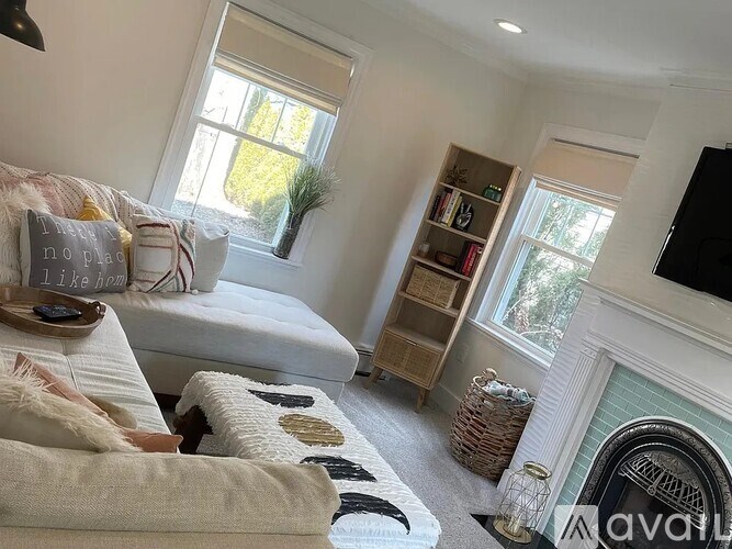 A cozy bedroom with a fireplace and a bed with a blanket.
