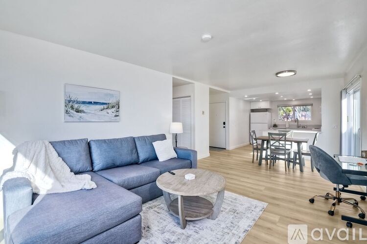 A living room with a grey couch and a coffee table.