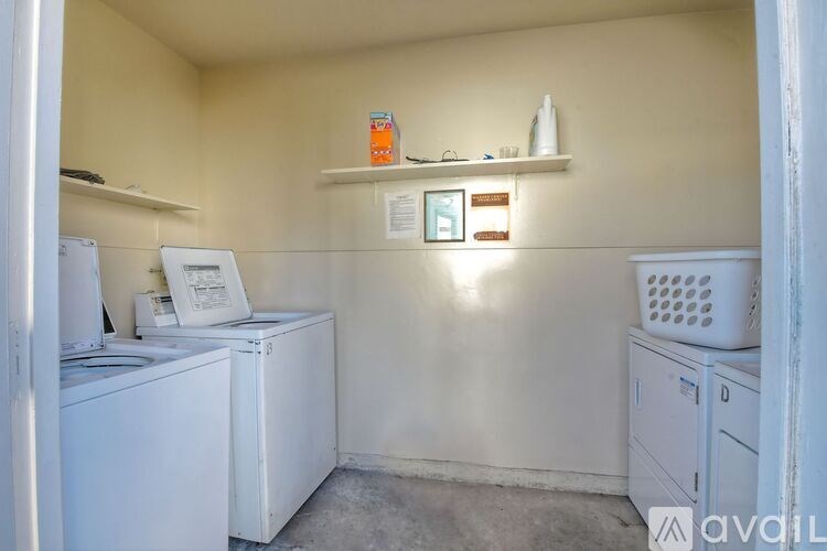 A small laundry room with a washer and dryer.