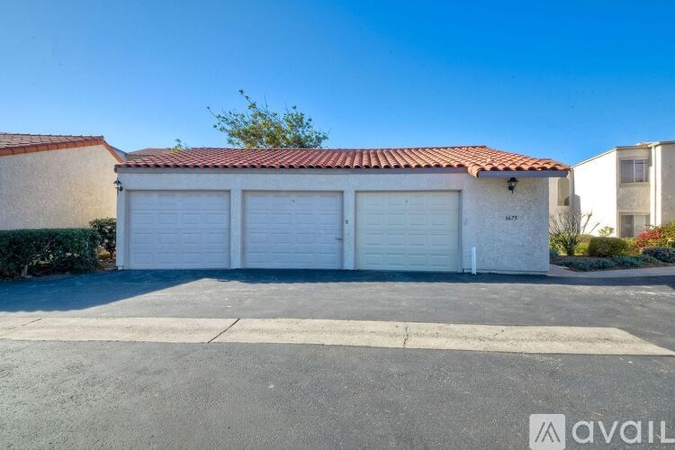 A two-car garage with a red tile roof is available for rent.