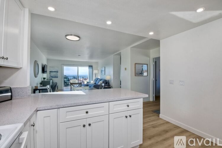A kitchen with white cabinets and a countertop.
