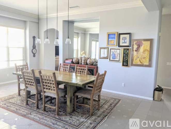 A dining room with a table and chairs.