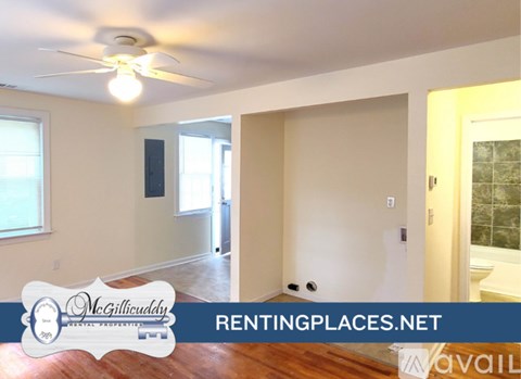 A room with a window and wooden floors is available for rent.
