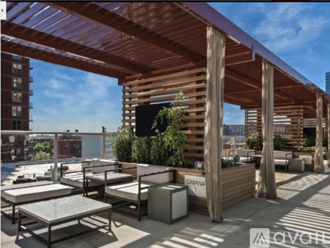 A wooden patio with tables and chairs and a sign that says "CABANA".