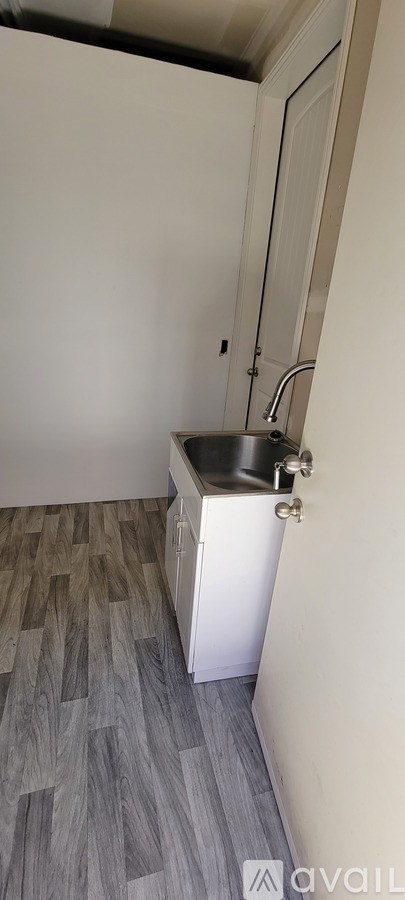 A kitchen with a sink and a cabinet.