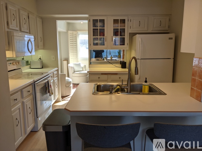 A kitchen with a sink and a refrigerator.