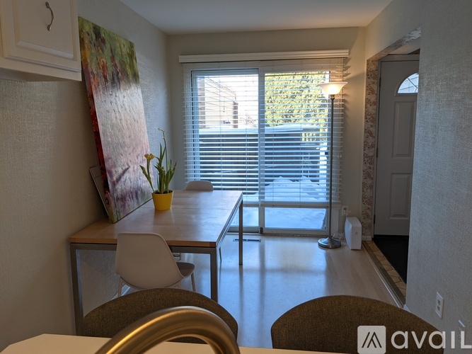 A dining room with a table and chairs.