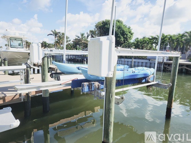 A boat is docked at a pier with a white box on top of it.