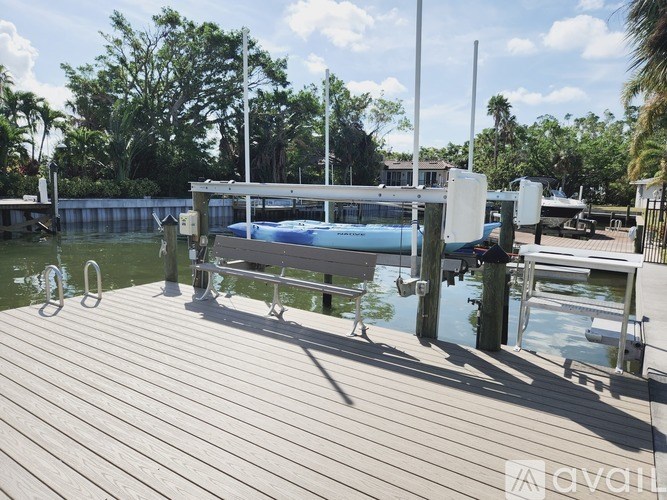 A wooden dock with a boat and a swimming pool.