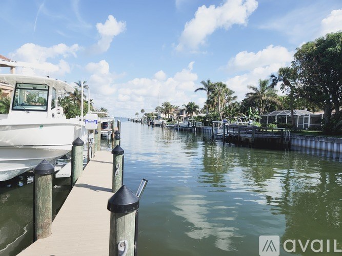 A boat is docked at a pier on a sunny day.
