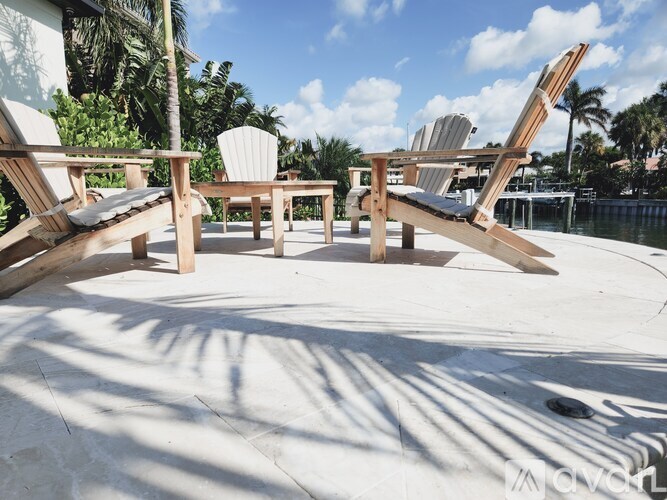 A wooden table and chairs are set up on a patio.
