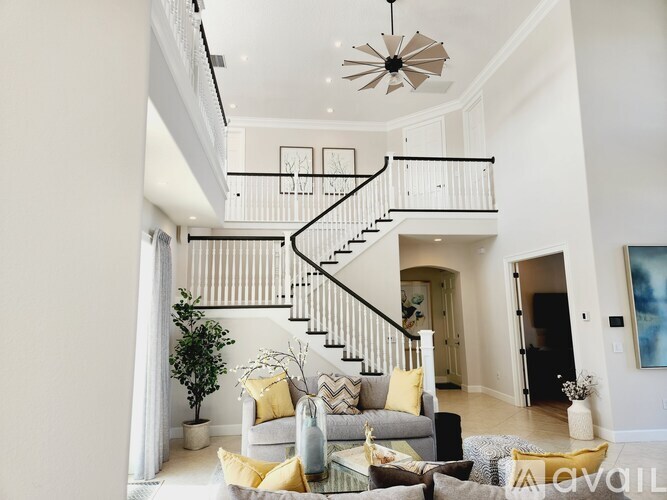 A living room with a staircase and a couch.