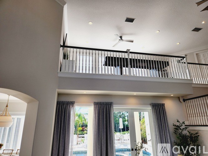 A modern house with a balcony and a pool.