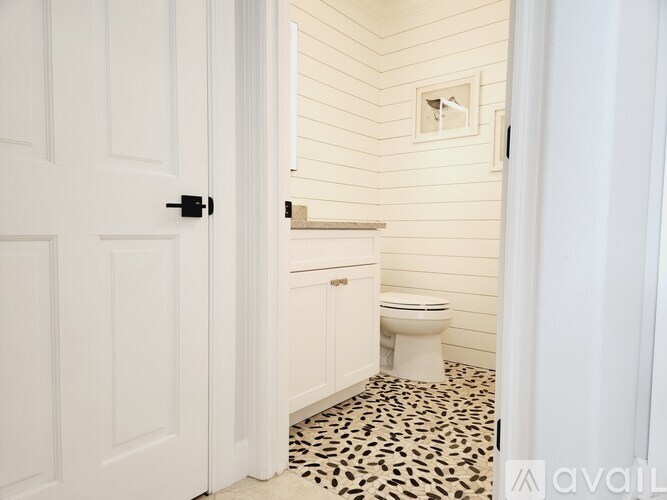 A bathroom with a toilet and a door.