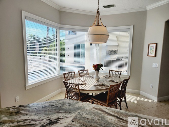 A dining room with a table set for four.