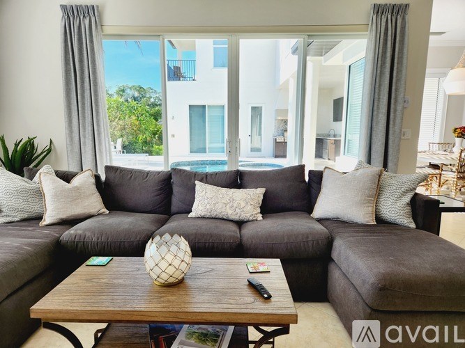 A living room with a grey sofa and a wooden coffee table.