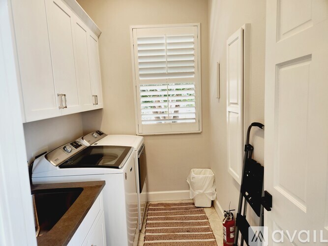 A small laundry room with a washer and dryer.