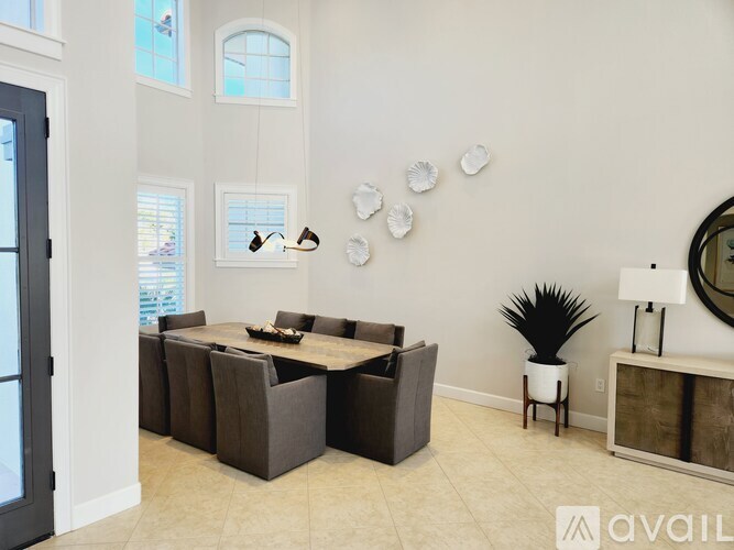 A modern dining room with a large table and chairs.