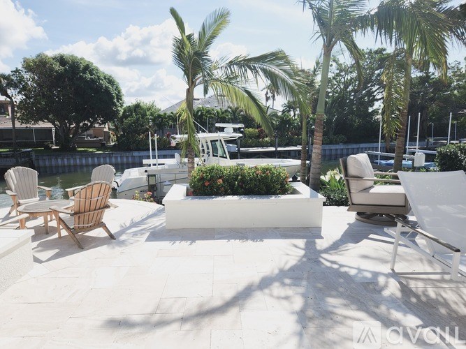 A patio with chairs and a planter box.