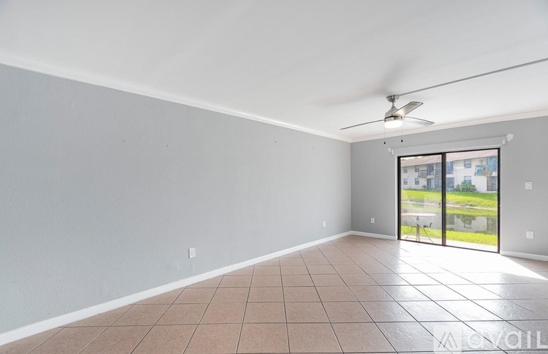 A room with a sliding glass door leading to a balcony.